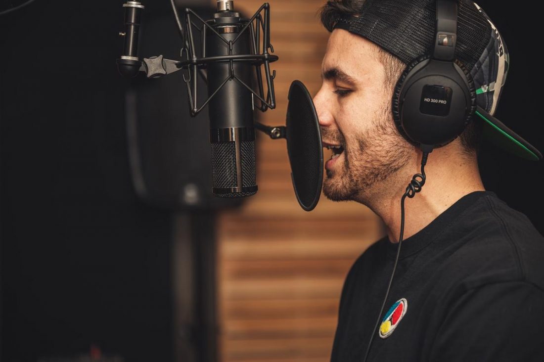The Reason Behind Singers Wearing Headphones During Recording